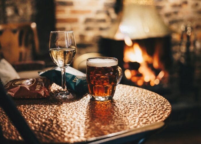 clear drinking glass with brown liquid on brown wooden table
